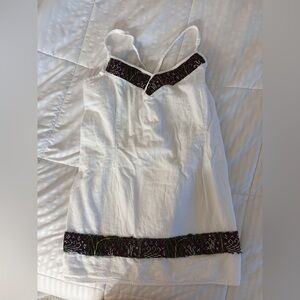 White Sleeveless Top with Black Trim.